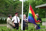 Chief Armand La Barge, Bill Fisch, Dave Barrow and Dave Williams raise the Rainbow Flag at the Community Safety Village during our picnic and BBQ event.