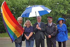 Despite the damp conditions, the Rainbow Flag is raised at Aurora town hall. Despite the damp conditions, the Rainbow Flag is raised at Aurora town hall.
